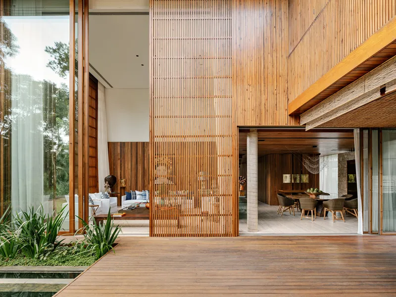 Courtyard view showing layered timber screens and decking connecting interior living spaces
