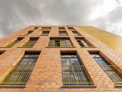 ASA Studio Stacks Offices and Apartments in a Naturally Ventilated Brick Tower Above Kigali's Rooftops