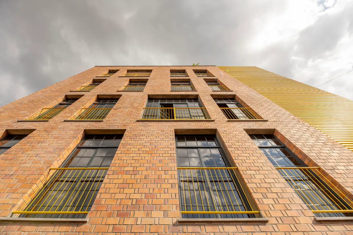 ASA Studio Stacks Offices and Apartments in a Naturally Ventilated Brick Tower Above Kigali's Rooftops