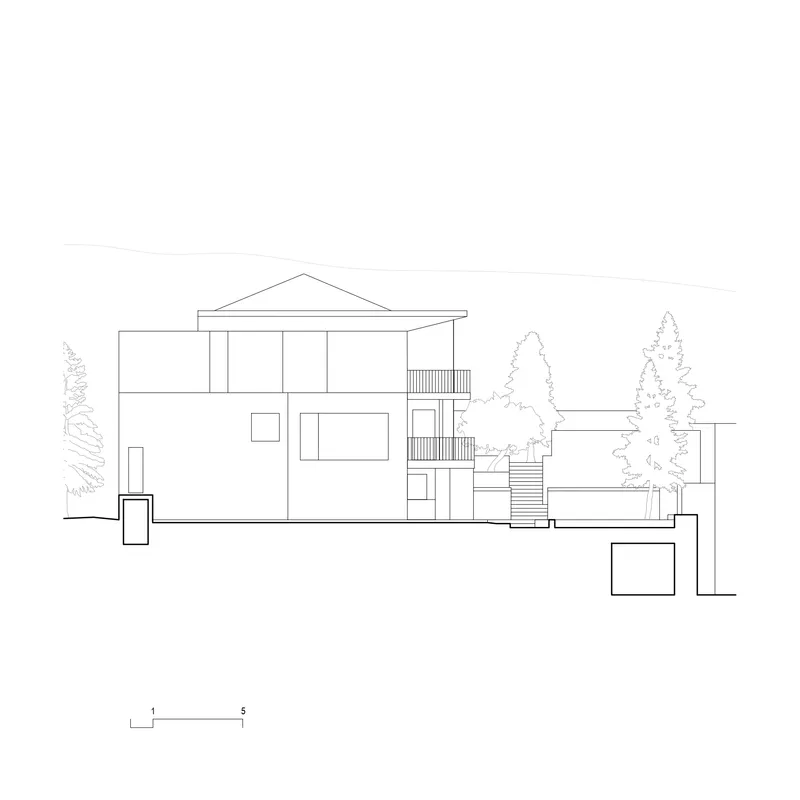 Elevation drawing depicting a two-story facade with external stairs and gabled roof with neighboring trees