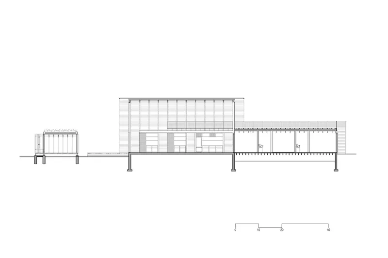 Section drawing revealing split-level interior arrangement beneath sloped roof with exposed structure