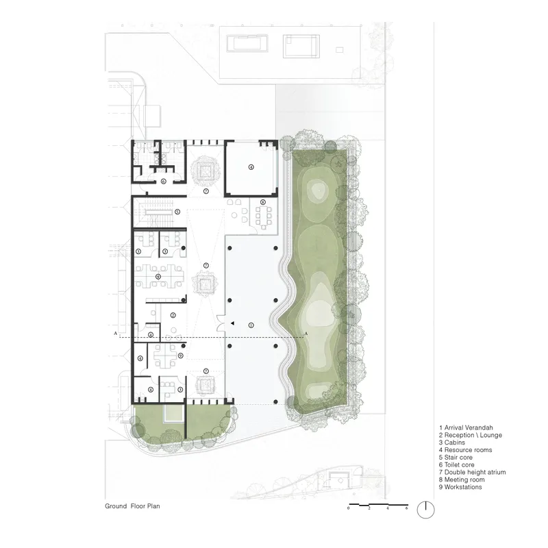 Ground floor plan showing office spaces arranged around a linear courtyard with landscaping