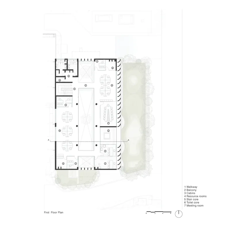 First floor plan showing walkway and workspaces wrapping around an open atrium void