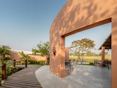 BodinChapa Architects Wraps a Rice-Grain Restaurant in Curved Brick on a Thai Paddy Field