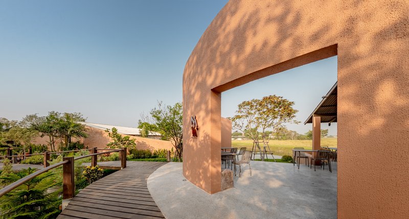 BodinChapa Architects Wraps a Rice-Grain Restaurant in Curved Brick on a Thai Paddy Field