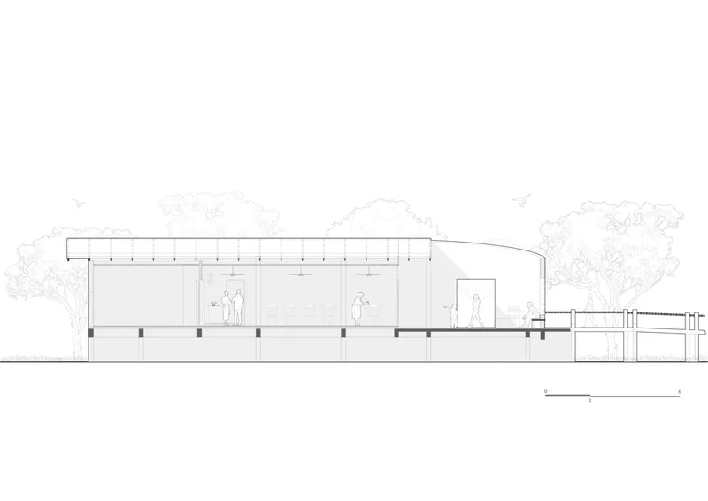 Elevation drawing of the single-story structure with flat roof and raised terrace flanked by trees