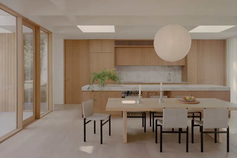 Dining area with timber cabinetry, stone countertop, and skylights above the table