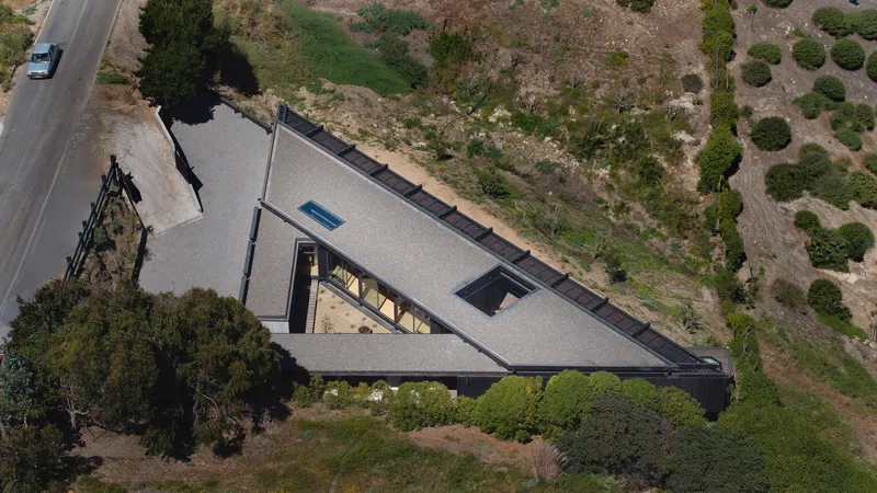 Overhead view of the triangular roof with central skylight and dark membrane roofing