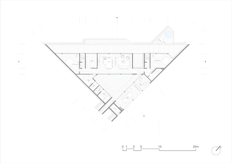 Floor plan drawing showing a linear central volume flanked by angled wings and service spaces