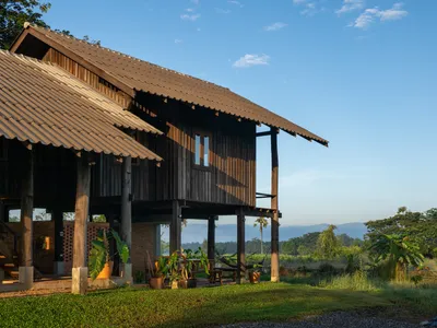 Yangnar Studio Raises a Timber Farmhouse on Stilts Above the Rice Fields of Chiang Mai