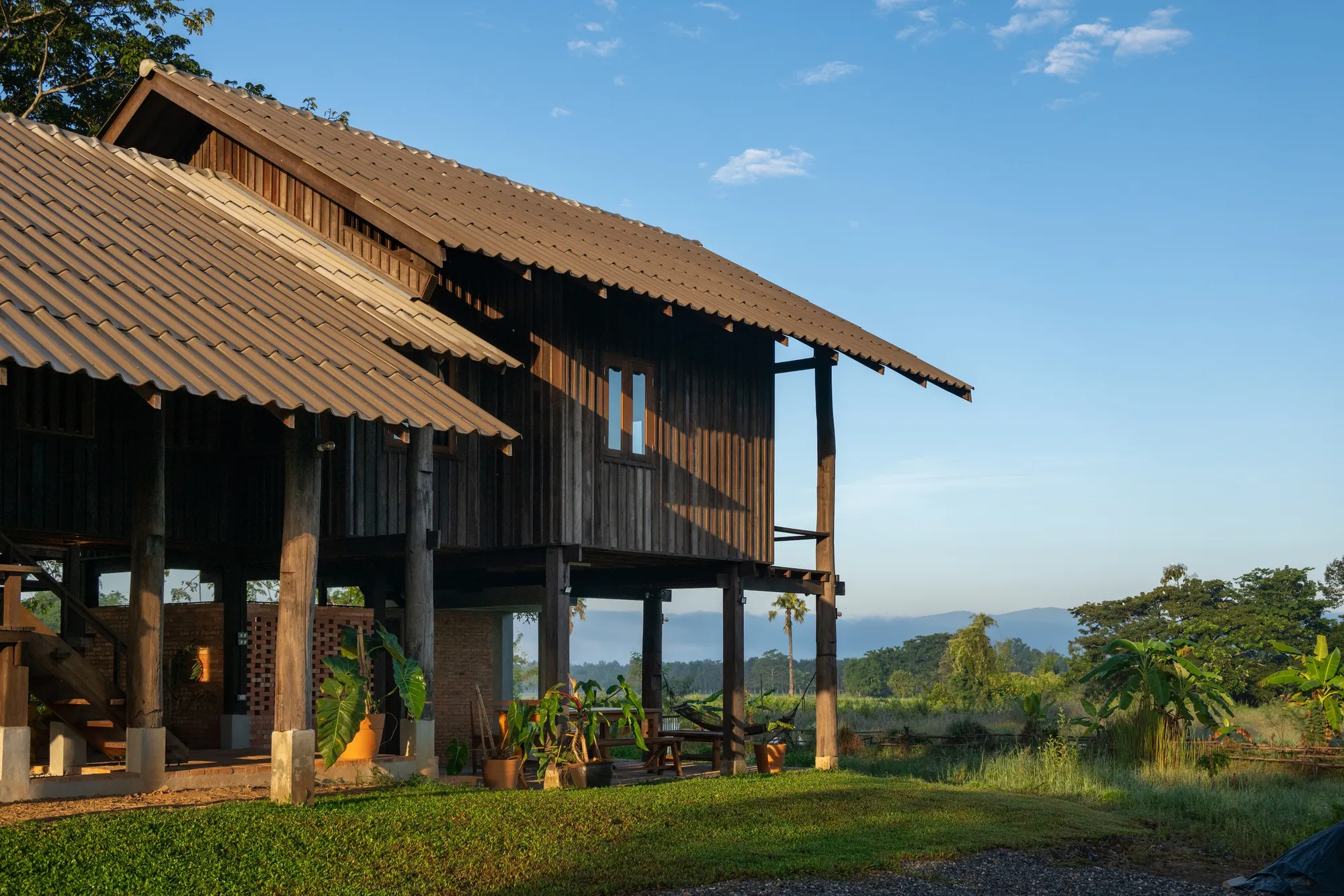 Yangnar Studio Raises a Timber Farmhouse on Stilts Above the Rice Fields of Chiang Mai
