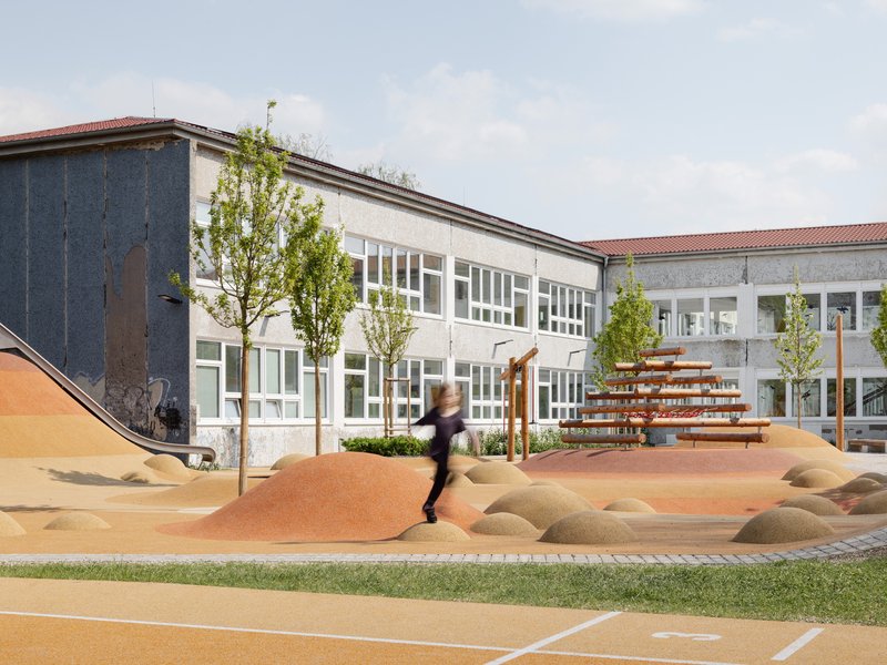 Sculptural playground with orange surfacing and mounded forms beside a white-framed school building facade