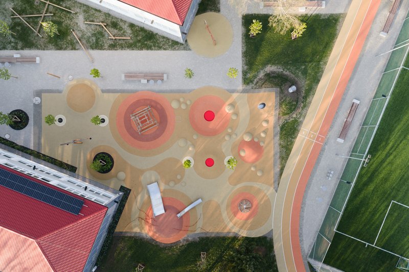Overhead view of the play yard showing concentric circles and colored climbing mounds