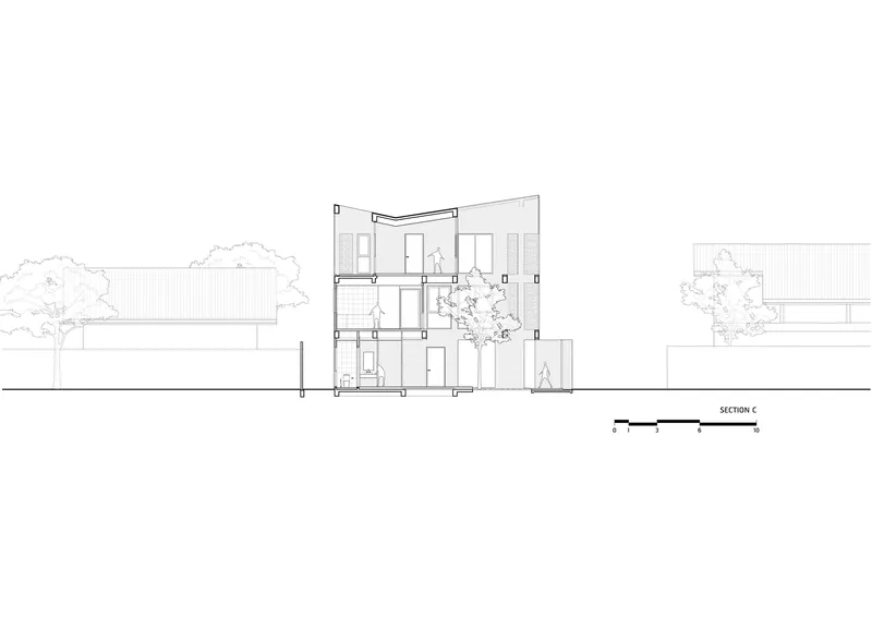 Section drawing showing a three-storey volume with a central tree and adjacent low-rise structures