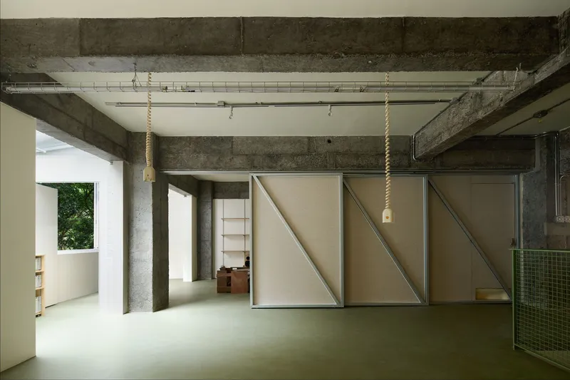 View of the movable partition panels in a closed configuration revealing diagonal timber bracing