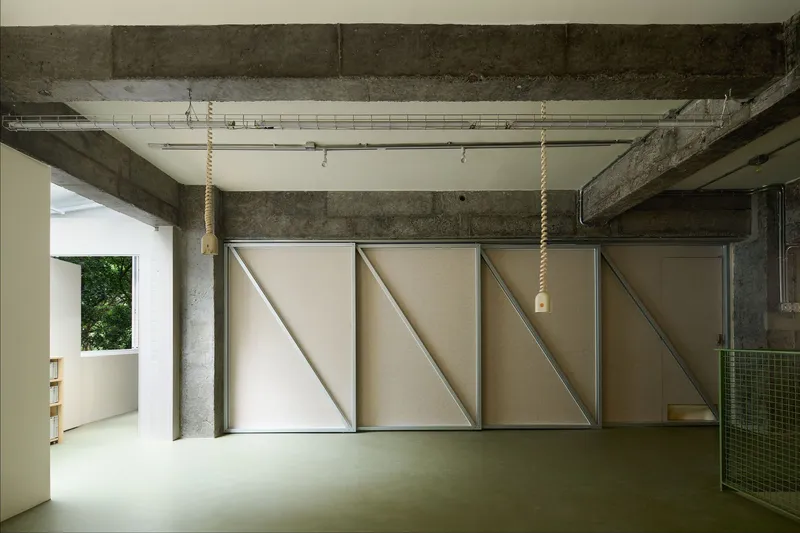 Three sliding panels with triangular bracing fully extended across the concrete frame space