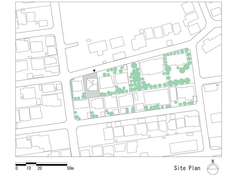 Site plan drawing showing building footprints and street trees in a dense residential block