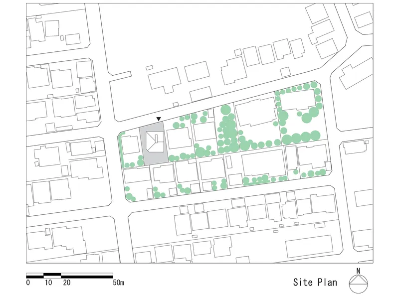 Site plan drawing showing building footprints and street trees in a dense residential block