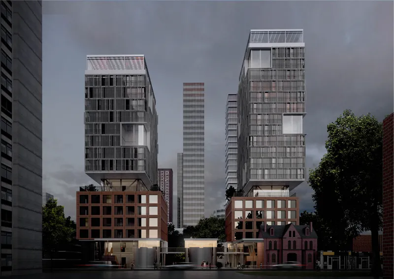 Evening view of the twin housing volumes, podium blocks, heritage structure, and illuminated communal ground plane.
