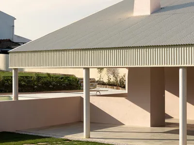 Vasco Burnay Wraps a Pink L-Shaped House in a Deep South-Facing Porch in Vila Franca de Xira