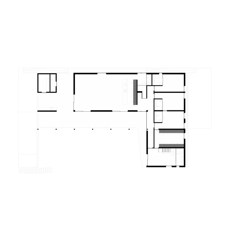 Floor plan drawing showing an L-shaped layout with open living space and enclosed bedrooms