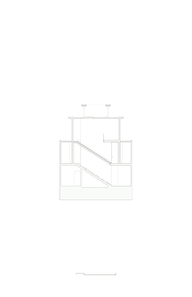 Section drawing showing three-story residence with diagonal staircase connecting stacked volumes