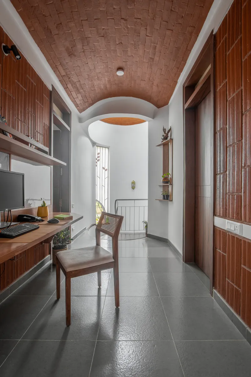 Corridor with basket-weave terracotta ceiling and vertical timber wall cladding