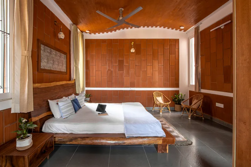 Bedroom with timber paneled walls and ceiling featuring a horizontal strip of concealed lighting