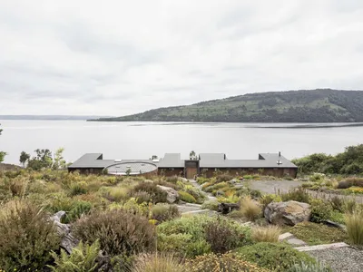 Triangular Floats a Lake House on Point Supports Above Chile's Humid Volcanic Shore