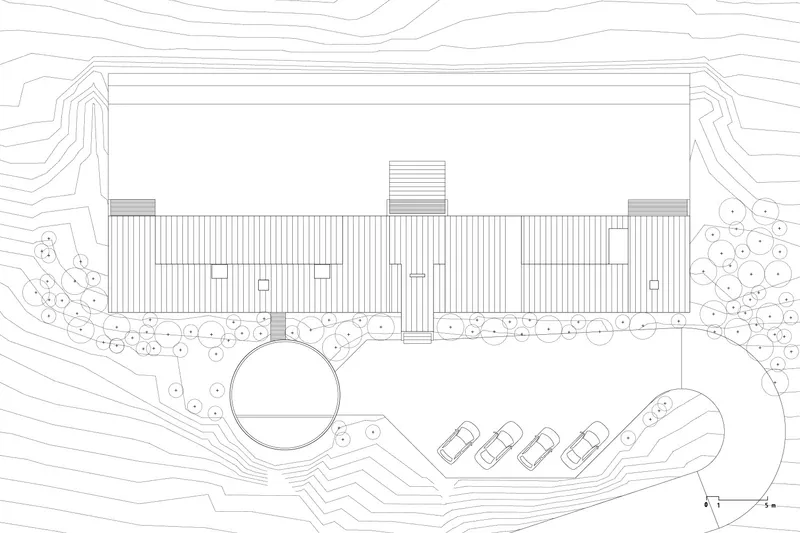 Roof plan drawing depicting the vertical-seamed metal roof with central skylight and curved site access