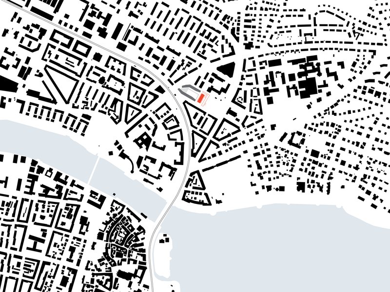 Site plan drawing showing the building footprint adjacent to a waterfront and dense urban fabric