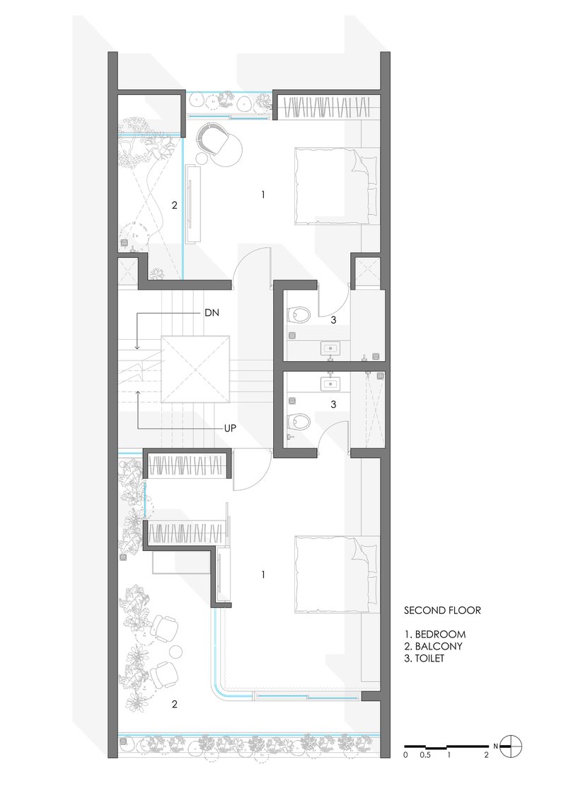 Floor plan drawing of second level showing two bedrooms with balconies and central stairwell