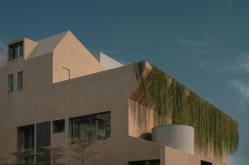 Corner view showing stacked stucco volumes with hanging greenery and a curved balcony projection