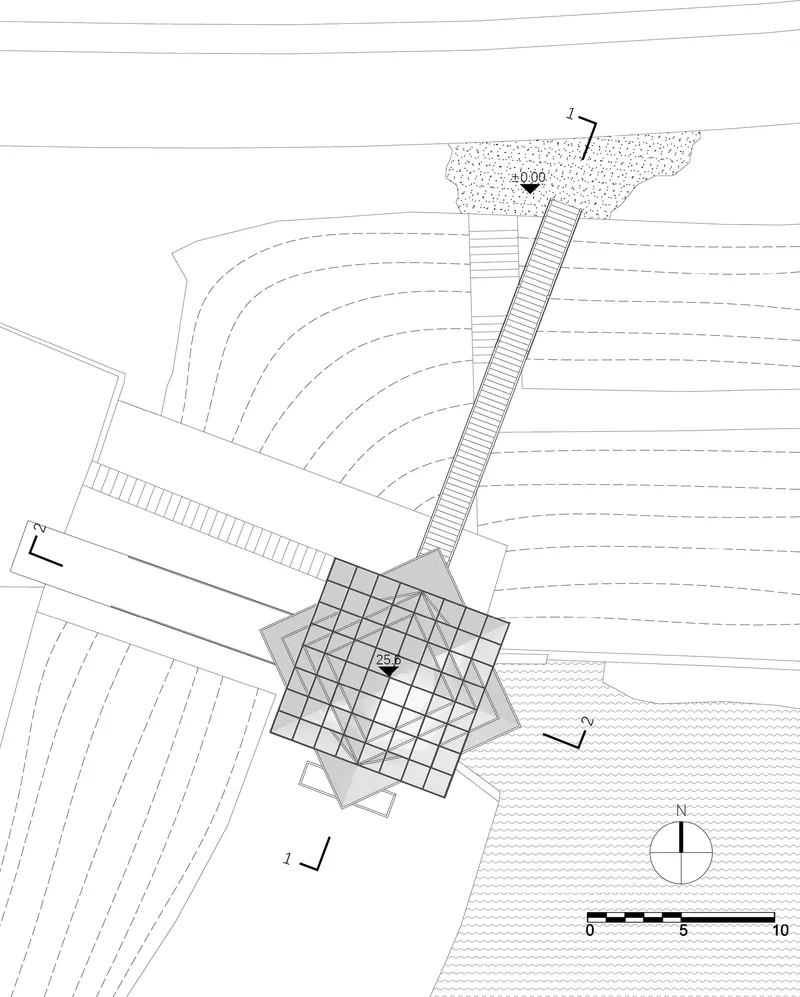 Site plan drawing showing the tower base with gridded footprint, elevated walkway and surrounding contour lines