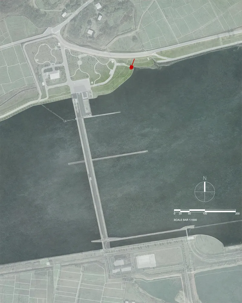 Aerial site plan rendering depicting a waterfront location with piers and a marked pavilion along the shore