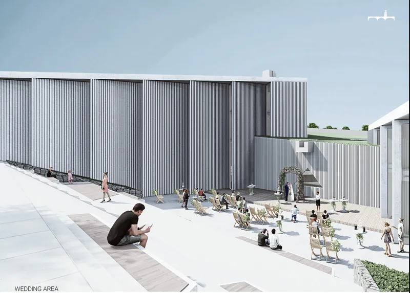 Wedding area framed by minimal white volumes, vertical facades, and open vineyard-facing terraces.