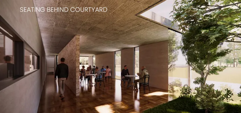 Courtyard seating area creating a quieter, private café atmosphere surrounded by natural light and greenery.
