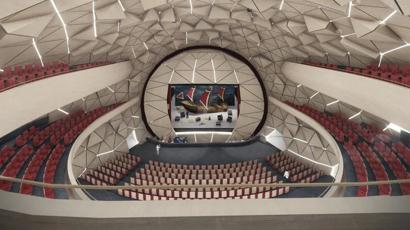 Interior rendering of the auditorium with tiered seating and a geometric faceted ceiling illuminated by accent lights