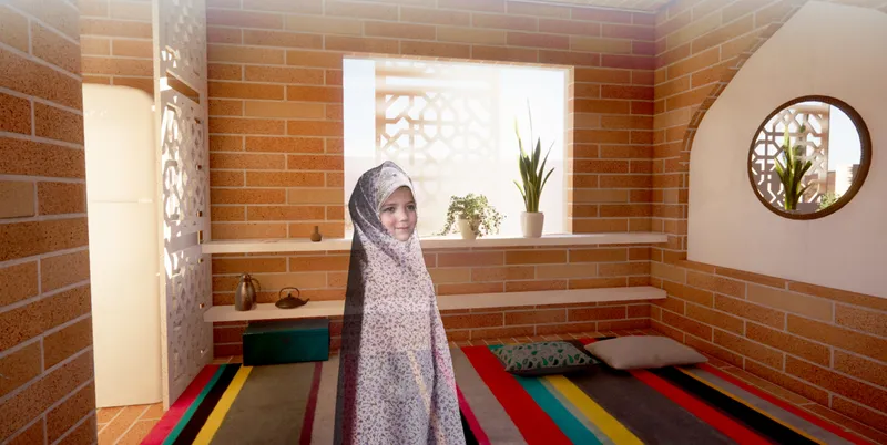 Warm interior design using brick walls, filtered daylight, and culturally responsive residential details.