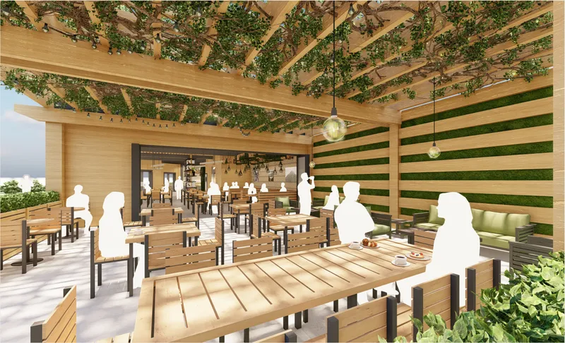 Outdoor patio seating framed by timber pergola, greenery, and a direct visual connection to the café interior.