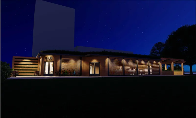 Night exterior view showing The Hub Coffee Bar’s illuminated timber façade, louvre screens, and park-facing presence.