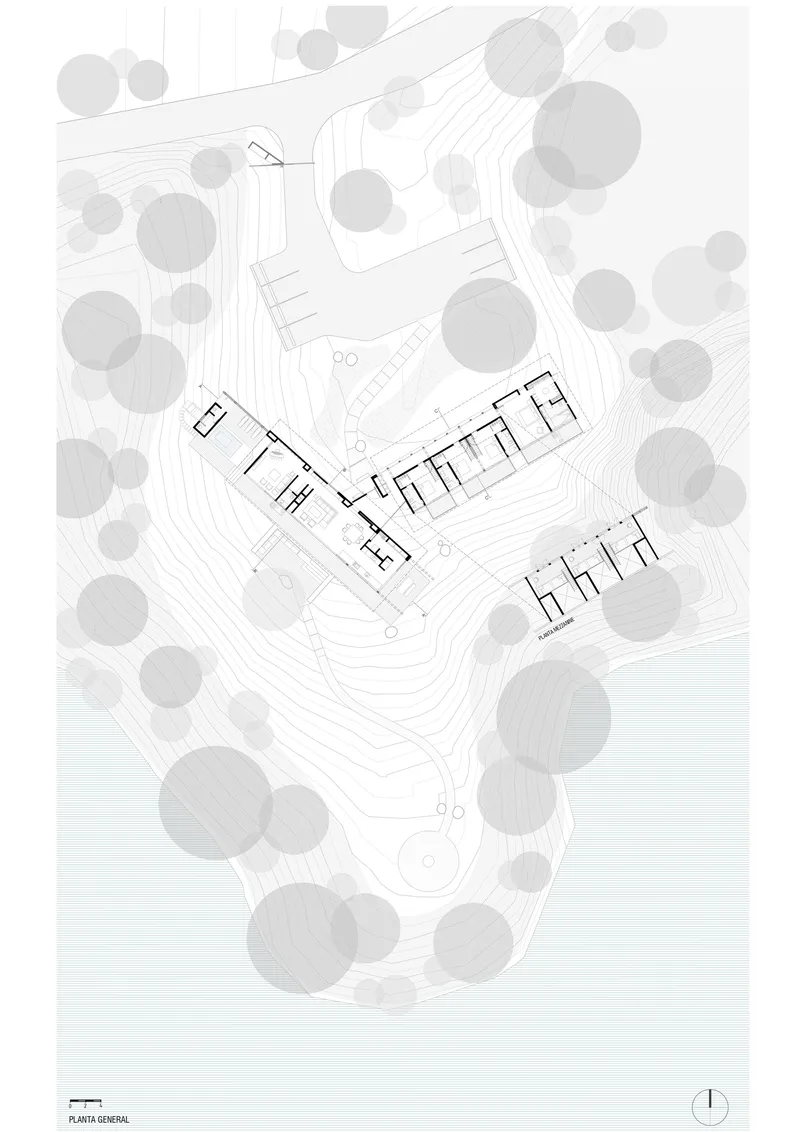 Floor plan drawing showing two linear wings with interior room divisions nestled in a wooded hillside