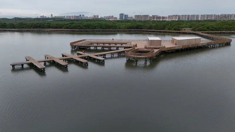 Aerial view of the waterfront boardwalk with pavilions and pier extensions under overcast sky