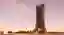 This architectural image showcases a futuristic skyscraper with a unique, parametric design. The bui