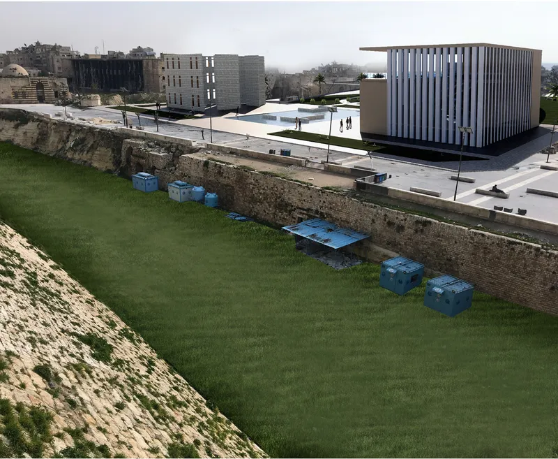 Elevated view of a grass lawn beside ancient stone walls with blue storage containers