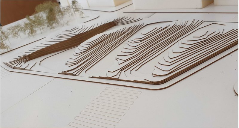 Close-up of the architectural model revealing individual laminated roof layers with slotted openings