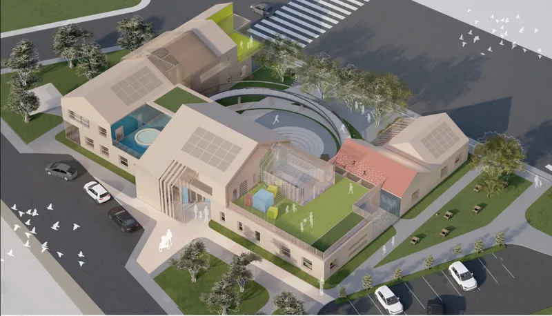 Aerial view of the complex with rooftop courtyards, circular stepped seating, solar arrays, and surrounding street trees