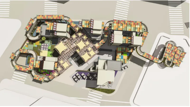 Plan view rendering showing the organic layout of interconnected volumes around central courtyards and parking zones