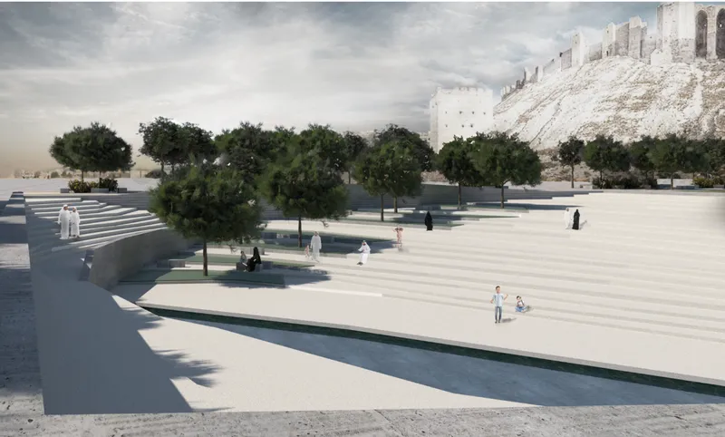 Open plaza with scattered pine trees and visitors walking near ancient citadel ruins