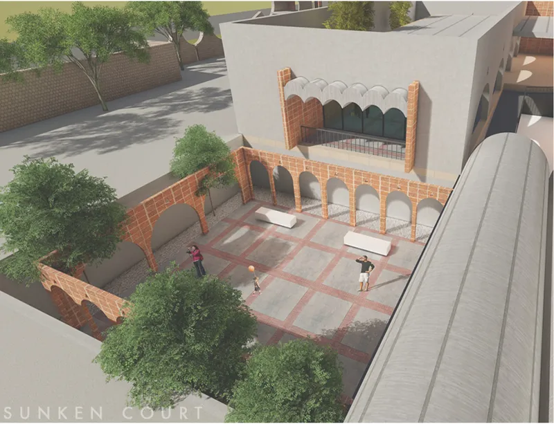 Aerial view of a sunken courtyard enclosed by red brick arcades and white stucco volumes with trees